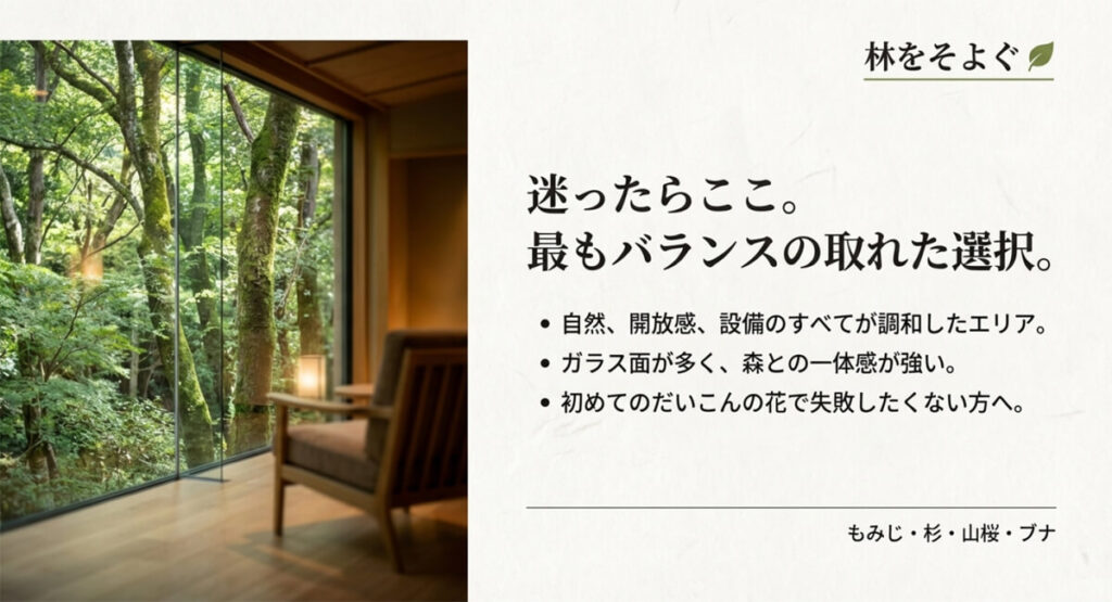 大きなガラス窓から鮮やかな新緑の森が見える客室内部の写真